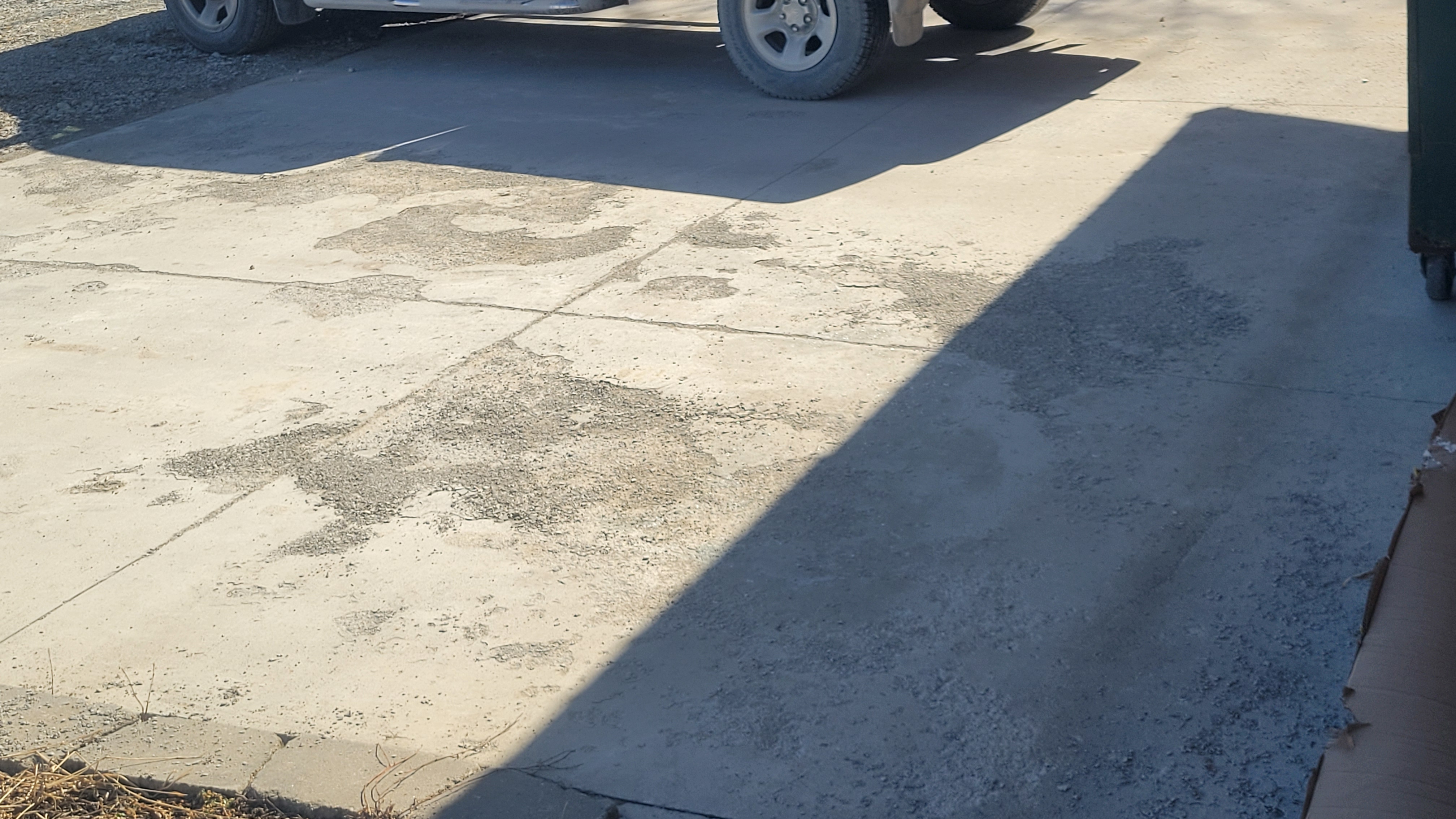 stapes concrete and grading distressed driveway
