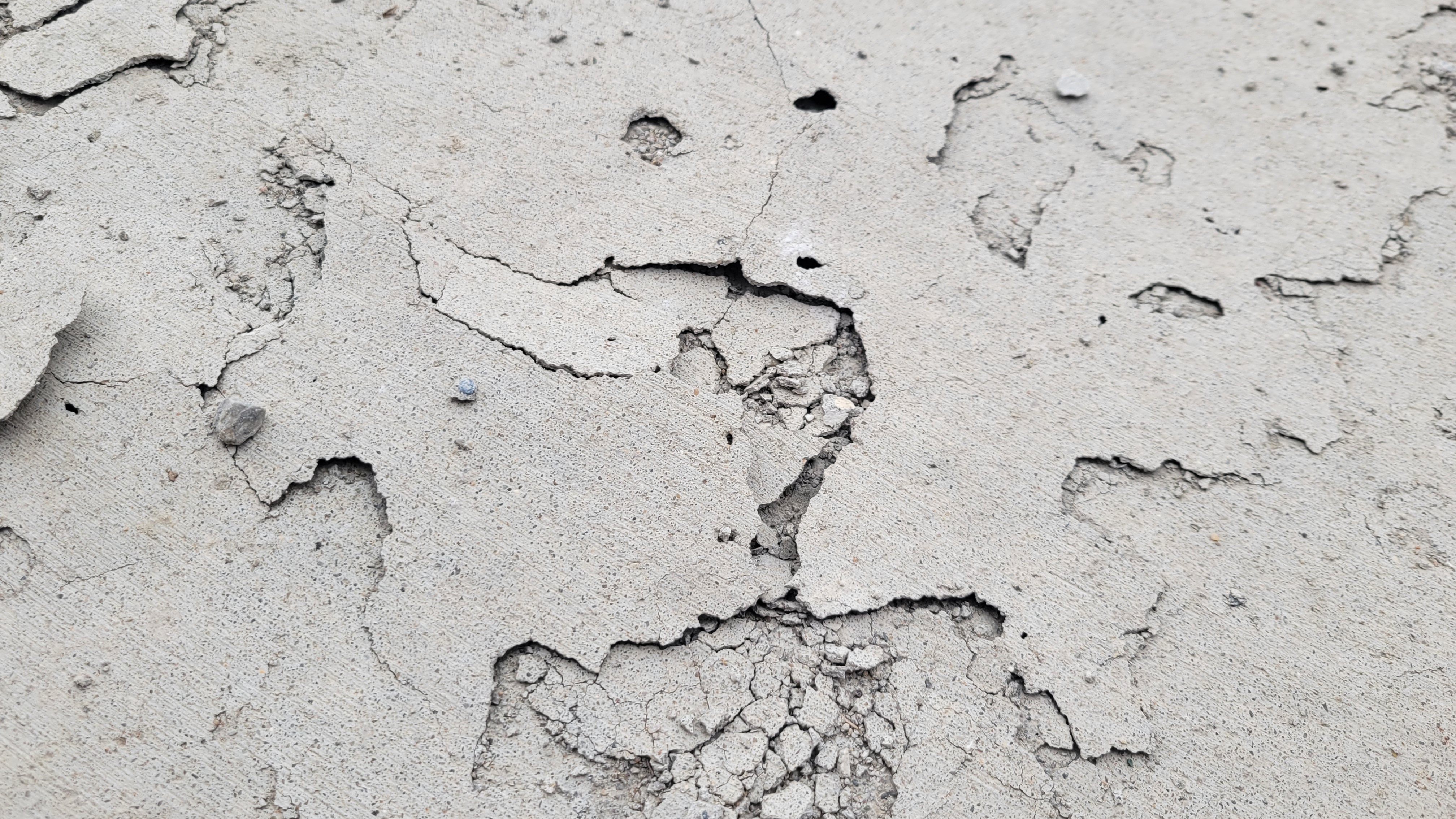 stapes concrete and grading distressed driveway